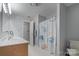 Bright bathroom featuring a double sink vanity, marine-themed shower curtain, and tiled floors at 2370 Old Mountain Rd, Statesville, NC 28625