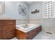 Bathroom featuring a soaking tub with jets, tile surround, and vanity at 2370 Old Mountain Rd, Statesville, NC 28625