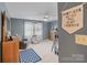 A bedroom with cozy chairs, neutral colors and a decorative 'Brothers Make the Best Friends' banner at 2370 Old Mountain Rd, Statesville, NC 28625