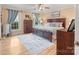 Bedroom features a large bed, hardwood floors, blue accent curtains, and bright sunlight at 2370 Old Mountain Rd, Statesville, NC 28625