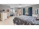 Bright bedroom with dinosaur themed comforter, desk, and large window for ample natural light at 2370 Old Mountain Rd, Statesville, NC 28625