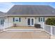 Spacious wooden deck featuring white railings, seating, and a sliding glass door entrance at 2370 Old Mountain Rd, Statesville, NC 28625