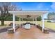 Covered outdoor gazebo featuring benches, ceiling fans, and a brick-paved floor at 2370 Old Mountain Rd, Statesville, NC 28625