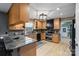 Well-equipped kitchen featuring wood cabinets, granite countertops, and stainless steel appliances at 2370 Old Mountain Rd, Statesville, NC 28625