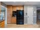 Kitchen includes wooden cabinets, a black refrigerator, and a microwave and coffee maker on the countertop at 2370 Old Mountain Rd, Statesville, NC 28625