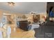 Inviting living room with a brick fireplace, hardwood floors, and an open view to the kitchen at 2370 Old Mountain Rd, Statesville, NC 28625