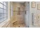 Tile shower with glass door, built-in seat, and decorative shelf at 2370 Old Mountain Rd, Statesville, NC 28625