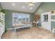 Bright sunroom features large windows, tile flooring, and flexible space for various activities at 2370 Old Mountain Rd, Statesville, NC 28625
