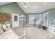 Bright sunroom features tile floors, coat rack, large windows, and charming decor at 2370 Old Mountain Rd, Statesville, NC 28625