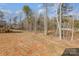Spacious backyard with a view of the house and back deck, surrounded by mature trees and natural beauty at 2385 Kool Park Ne Rd # 2, Hickory, NC 28601