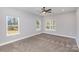 Bright bedroom with neutral carpet and multiple windows overlooking the outdoor deck at 2385 Kool Park Ne Rd # 2, Hickory, NC 28601