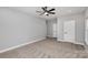 Spacious bedroom with neutral carpet, ceiling fan, and two doors at 2385 Kool Park Ne Rd # 2, Hickory, NC 68601