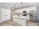 Modern kitchen with stainless steel appliances, a central island, and sleek white cabinetry at 2385 Kool Park Ne Rd # 2, Hickory, NC 28601