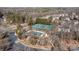 Aerial view of the community clubhouse, pool, and tennis courts, surrounded by mature trees and landscaping at 2418 Lexington Approach Dr, Charlotte, NC 28262