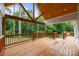 A spacious back porch boasts a vaulted wood ceiling, ample natural light, and a wooden railing offering a cozy outdoor space at 2418 Lexington Approach Dr, Charlotte, NC 28262