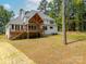 Expansive backyard featuring a spacious deck and open-beam porch, all surrounded by lush greenery and mature trees at 2418 Lexington Approach Dr, Charlotte, NC 28262