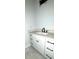 Contemporary bathroom features white cabinets, black hardware, and stone countertops at 2418 Lexington Approach Dr, Charlotte, NC 28262