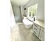 This bathroom features a soaking tub with black matte fixtures and dual sink vanities at 2418 Lexington Approach Dr, Charlotte, NC 28262