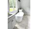 Bright bathroom featuring a soaking tub, neutral tiling and dual sink vanities at 2418 Lexington Approach Dr, Charlotte, NC 28262