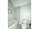 Modern bathroom with a sleek tub, contemporary fixtures, and stylish tile surround at 2418 Lexington Approach Dr, Charlotte, NC 28262