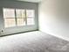 Cozy bedroom with natural light streaming through a window, featuring comfortable carpeting and a serene atmosphere at 2418 Lexington Approach Dr, Charlotte, NC 28262