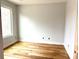 Bedroom features hardwood floors, natural light from a window, and neutral wall colors at 2418 Lexington Approach Dr, Charlotte, NC 28262
