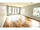 Spacious bedroom with hardwood floors, large windows, and double doors to the outside at 2418 Lexington Approach Dr, Charlotte, NC 28262