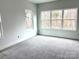 Bright bedroom with large windows offering natural light, complemented by plush carpeting for added comfort and style at 2418 Lexington Approach Dr, Charlotte, NC 28262