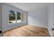 Spacious bedroom with hardwood floors and a large window that offers plenty of natural light at 2418 Lexington Approach Dr, Charlotte, NC 28262