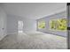 Large bedroom with neutral carpet, multiple windows, and fresh paint at 2418 Lexington Approach Dr, Charlotte, NC 28262