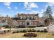 Brick clubhouse with white trim, dormer windows, and manicured landscaping welcomes residents and guests at 2418 Lexington Approach Dr, Charlotte, NC 28262