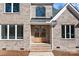 Inviting entrance with glass paneled double doors and classic brick at 2418 Lexington Approach Dr, Charlotte, NC 28262