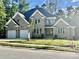 Attractive brick home with a two-car garage, manicured lawn, and large windows, creating curb appeal at 2418 Lexington Approach Dr, Charlotte, NC 28262