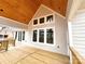 Stylish back porch with a wood ceiling, large windows, and a deck, perfect for outdoor living and entertaining at 2418 Lexington Approach Dr, Charlotte, NC 28262