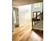 Foyer with wood floors, stairs, and a contemporary wooden double door entrance at 2418 Lexington Approach Dr, Charlotte, NC 28262