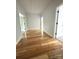 Hallway featuring hardwood floors and a view of doorways and a closet at 2418 Lexington Approach Dr, Charlotte, NC 28262