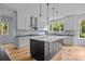 Modern kitchen with white cabinetry, a black island, and stainless steel appliances at 2418 Lexington Approach Dr, Charlotte, NC 28262