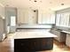 Spacious kitchen featuring a large island with a marble countertop, custom cabinets, and hardwood floors at 2418 Lexington Approach Dr, Charlotte, NC 28262