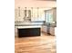 Modern kitchen featuring a central island, stainless steel appliances, marble backsplash and hardwood floors at 2418 Lexington Approach Dr, Charlotte, NC 28262