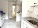 Kitchen featuring modern white cabinets, granite countertops, stainless steel sink, and an open layout at 2418 Lexington Approach Dr, Charlotte, NC 28262