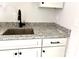 Modern kitchen sink features granite countertops, sleek faucet, and white cabinets with black pulls at 2418 Lexington Approach Dr, Charlotte, NC 28262