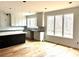A well-lit kitchen with white cabinets, dark countertops, a kitchen island, and new hardwood floors at 2418 Lexington Approach Dr, Charlotte, NC 28262