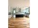 Open kitchen boasts a black center island, modern appliances, and a herringbone tile backsplash at 2418 Lexington Approach Dr, Charlotte, NC 28262