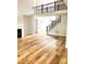 Bright living room with hardwood floors, fireplace, and a stairway to the upper level of the house at 2418 Lexington Approach Dr, Charlotte, NC 28262