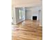 Spacious living room with hardwood floors, fireplace, and a view to the outside through many windows at 2418 Lexington Approach Dr, Charlotte, NC 28262