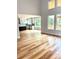 Open floor plan living room view with hardwood floors connecting to a kitchen with modern white cabinets at 2418 Lexington Approach Dr, Charlotte, NC 28262