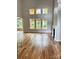 Bright living room with hardwood floors, fireplace, and many windows offering outdoor views at 2418 Lexington Approach Dr, Charlotte, NC 28262