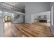 Open floor plan showcasing living room, kitchen, and staircase with hardwood floors at 2418 Lexington Approach Dr, Charlotte, NC 28262
