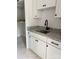 Mudroom area with white cabinets, granite countertop, and stainless steel sink at 2418 Lexington Approach Dr, Charlotte, NC 28262