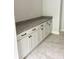 White cabinets and countertop with granite detail are featured in this mudroom at 2418 Lexington Approach Dr, Charlotte, NC 28262
